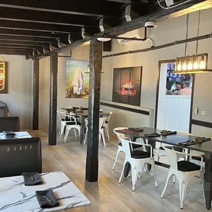 the interior of a restaurant with tables and chairs
