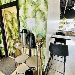 a room with a table, chairs, and a mirror