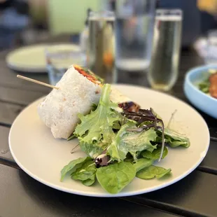 a plate of salad and a burrito
