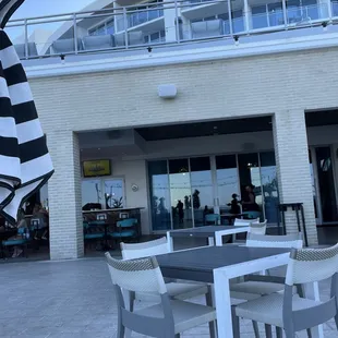 a patio area with a table and chairs