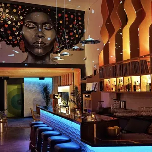 a bar with a mural of a woman's face
