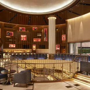 a circular dining area with a circular table and chairs