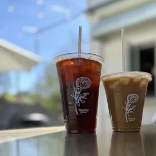 two cups of iced coffee on a table