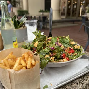 a plate of french fries and a salad