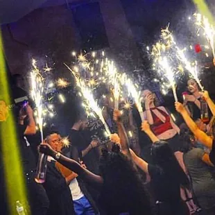 a group of people holding sparklers