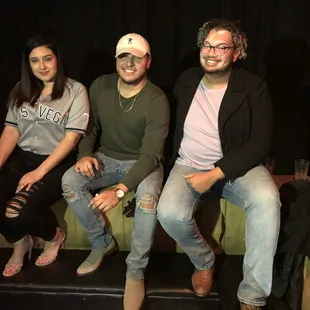 three people sitting on a couch