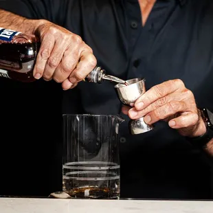 a man pouring a drink