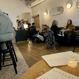 a group of people sitting at tables in a restaurant