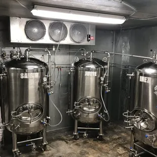 a row of stainless steel tanks
