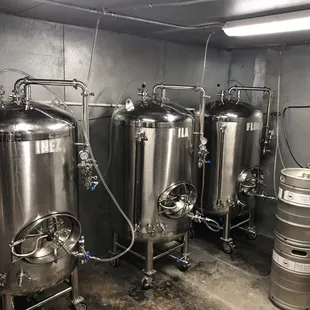 a row of stainless steel tanks