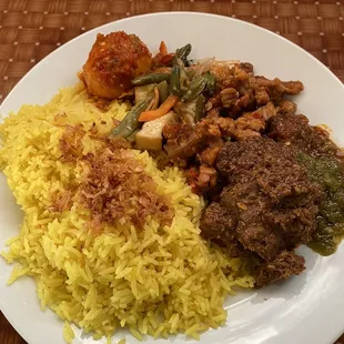 You can pick whatever toppings you want  In this pic: Nasi Kuning (yellow rice)  -telor balado -rendang -tempe manis -sayur buncis