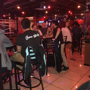 a group of people sitting at a bar