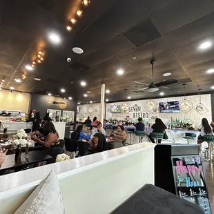 people sitting at tables in a restaurant