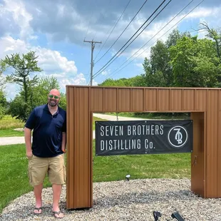 a man standing in front of a sign