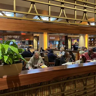people sitting at tables in a restaurant