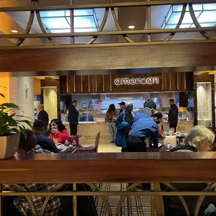 people sitting at tables in a restaurant