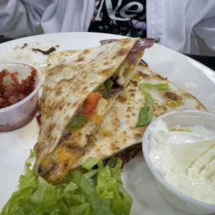 Half eaten delicious chicken quesadilla