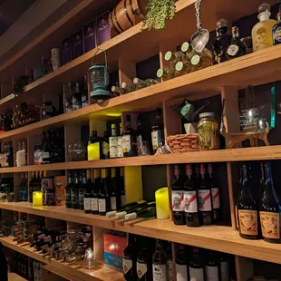 a shelf full of wine bottles