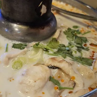 a bowl of soup with mushrooms and broccoli