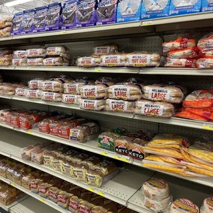 shelves of bread, rolls, and other foods