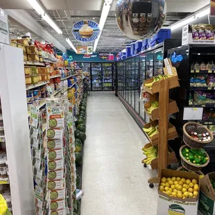 a grocery aisle with fruit and vegetables