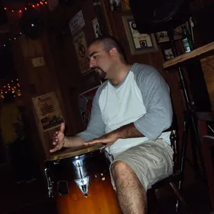 a man sitting in a chair with a drum