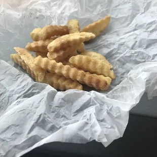 a person holding a basket of crisped fish sticks