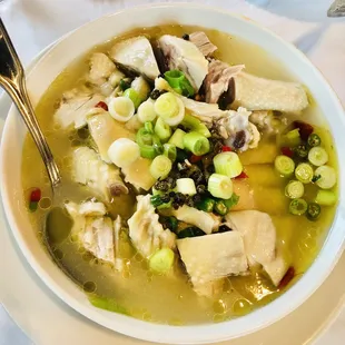 a bowl of soup with meat and vegetables
