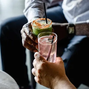 a man holding a glass of a drink