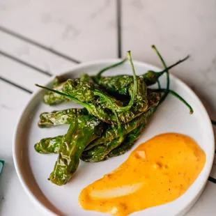 a plate of green peppers on a table