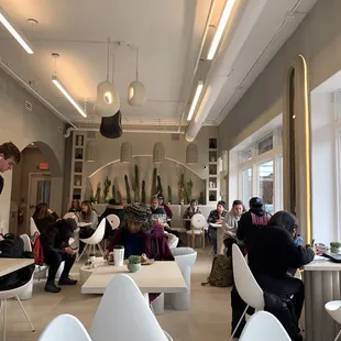people sitting at tables in a cafe