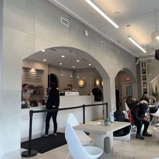 people sitting at tables in a cafe