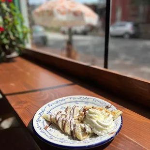 a plate of crepes on a window sill