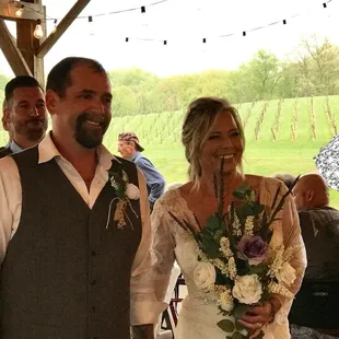 a bride and groom walking down the aisle