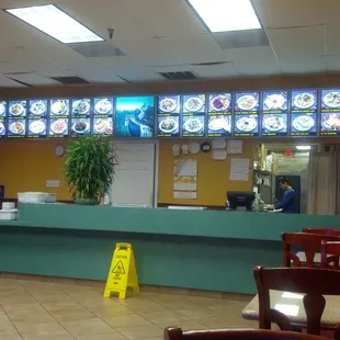 a restaurant counter with a lot of menus