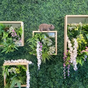 a wall of artificial plants and flowers