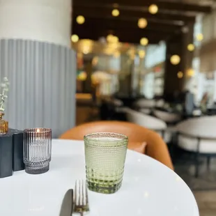 a glass of water and a fork on a table