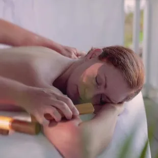 Premium wonder 90-minute bamboo massage in outdoor gazebo.