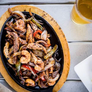 Combo Fajitas served on a sizzling cast iron pan