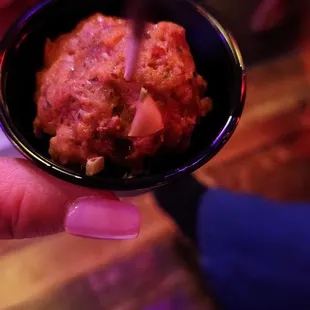 a person holding a bowl of food