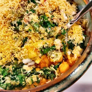 Closer look of the Sewa Chat (kale dipped in chickpea batter topped with yogurt, mint, tamarind chutney, tomato &amp; onion.)