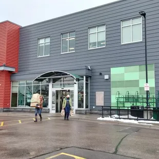 people walking in front of a building