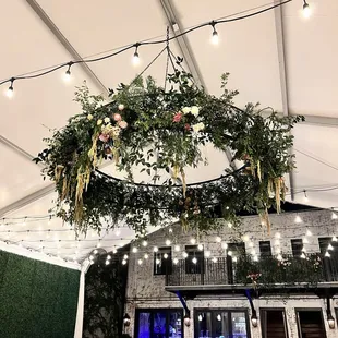 Chandelier on the patio, decorated with florals from Wild Botanical