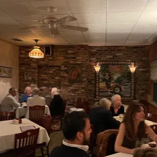 a group of people sitting at tables in a restaurant