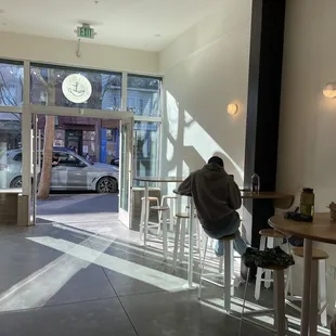 Entrance with afternoon lighting and multiple tables for seating
