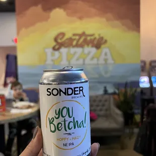 a person holding a can of soda