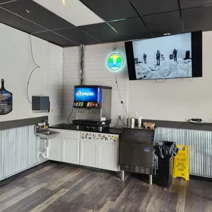 a kitchen with a flat screen tv