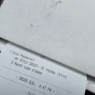 a receipt on a pizza box