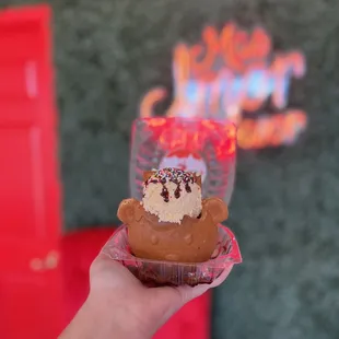 a hand holding a cupcake