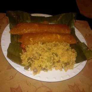 Yucca empanada made with either crab meat, pork or chicken with arroz con gandules.